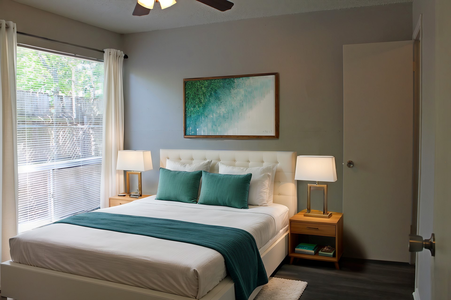 4510 Duval Street, Unit 204 Austin, TX 78751 - Photo 3 of 9 This room features a large window with blinds, dark wood-style flooring, a ceiling fan, and painted walls