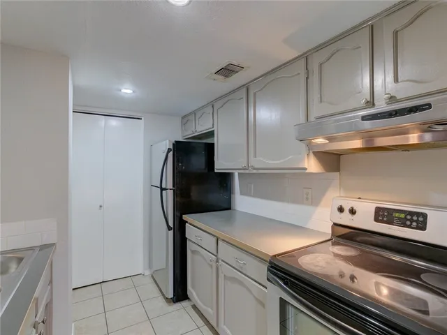 a kitchen with appliances and cabinets