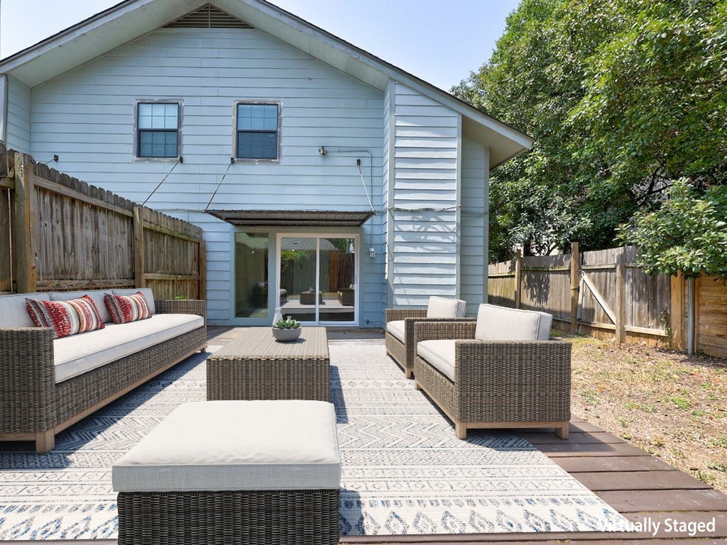 1710 Cinnamon Path Austin, TX 78704 - Photo 24 of 40 a view of a patio with couches and table and chairs with wooden floor and fence