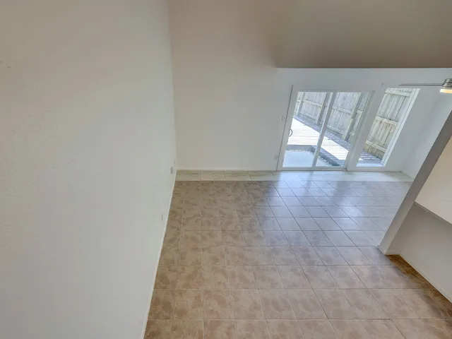 a view of an empty room with glass door
