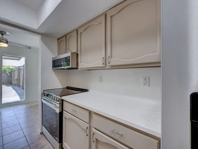 a kitchen with stainless steel appliances a stove a sink and a refrigerator