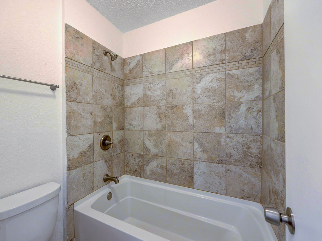 1710 Cinnamon Path Austin, TX 78704 - Photo 33 of 40 a bathroom with a bathtub and a toilet