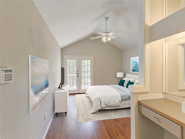 a bedroom with a large bed and a chandelier