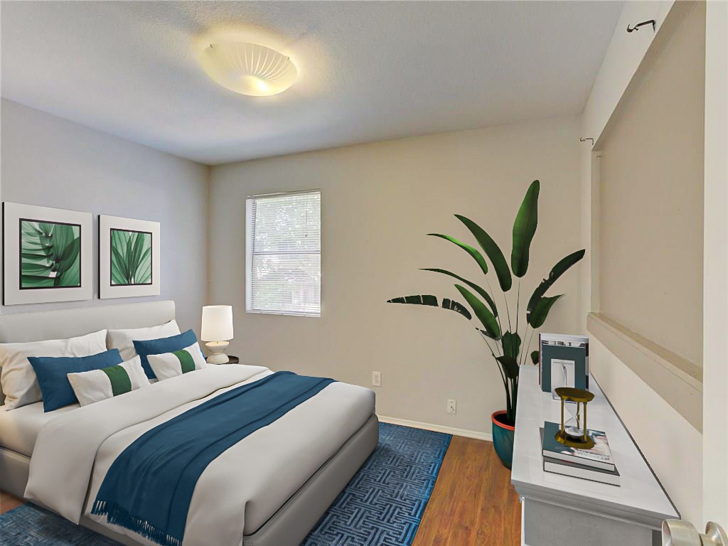 1710 Cinnamon Path Austin, TX 78704 - Photo 6 of 40 a bedroom with a large bed and a potted plant