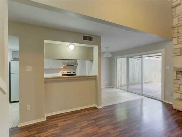 a view of an empty room and wooden floor
