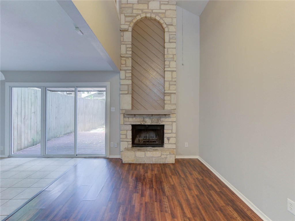 1710 Cinnamon Path Austin, TX 78704 - Photo 9 of 40 a view of empty room with wooden floor and fireplace