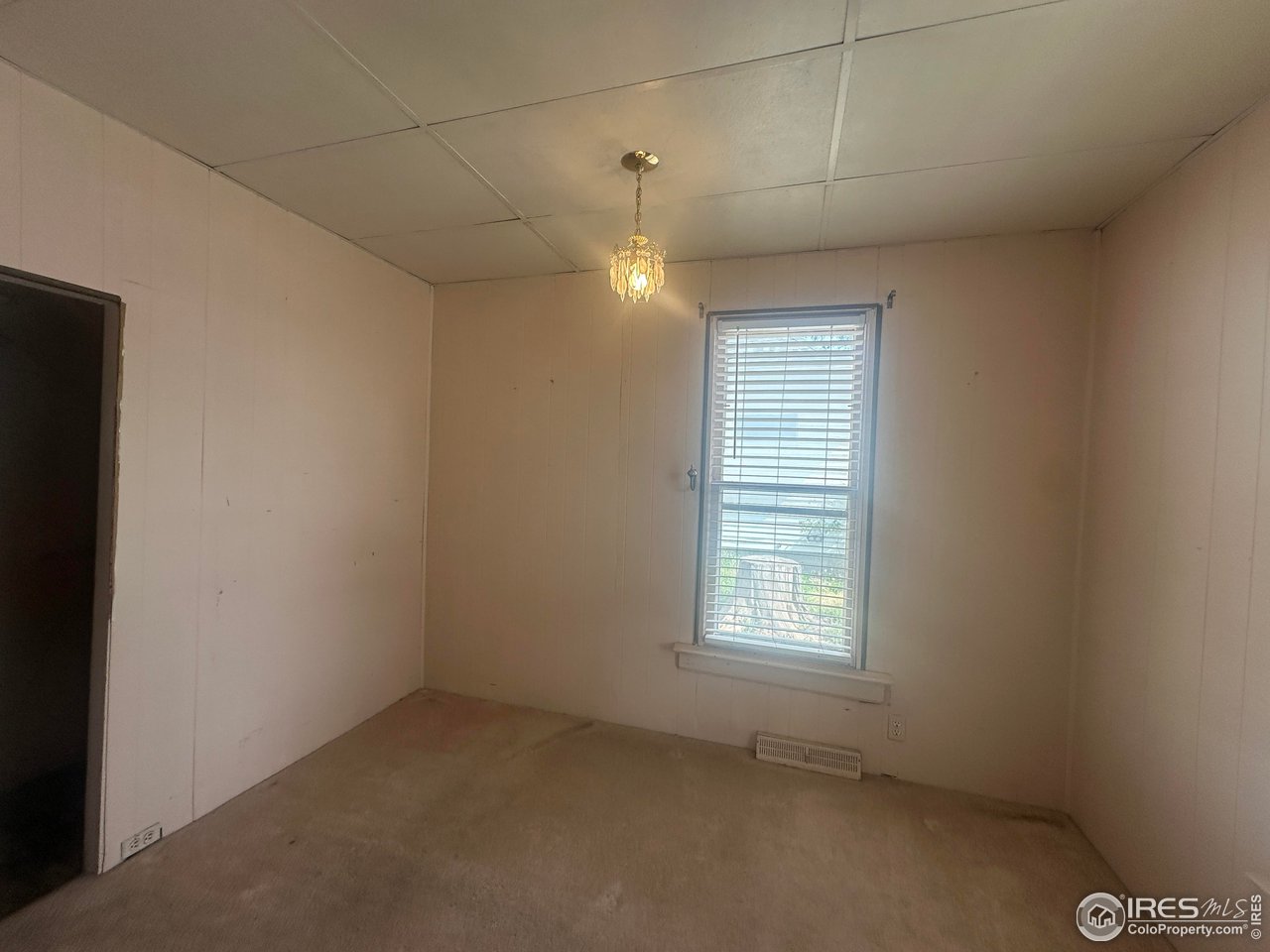 224 State Street Sterling, CO 80751 - Photo 11 of 23 an empty room with windows and fan
