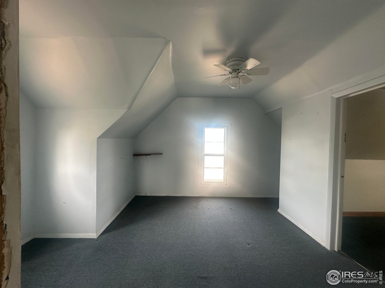224 State Street Sterling, CO 80751 - Photo 13 of 23 an empty room with windows and fan