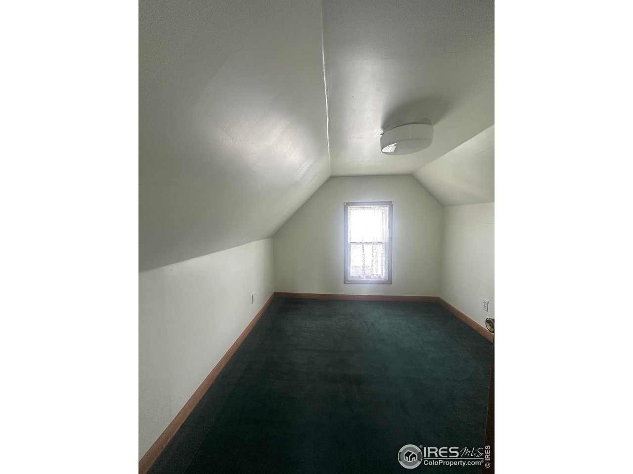 224 State Street Sterling, CO 80751 - Photo 14 of 23 a view of a hallway with a window