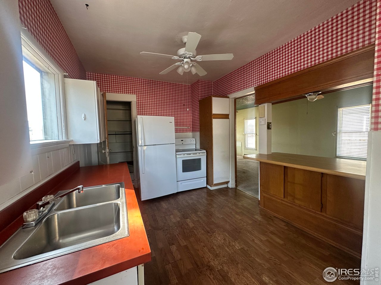 224 State Street Sterling, CO 80751 - Photo 4 of 23 a kitchen with kitchen island a counter top space appliances and a window