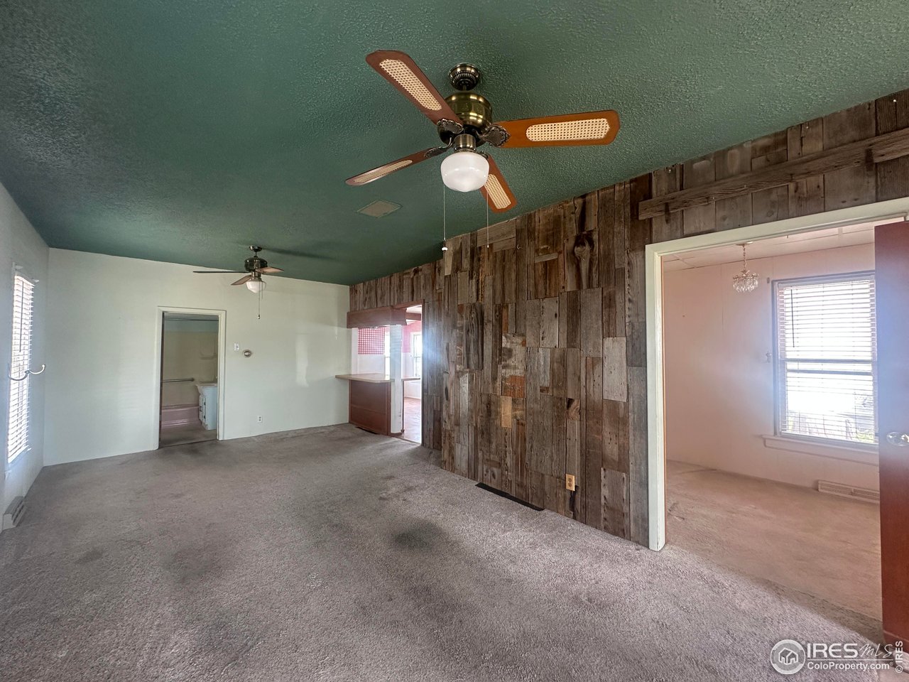 224 State Street Sterling, CO 80751 - Photo 10 of 23 a view of a livingroom with a ceiling fan and window