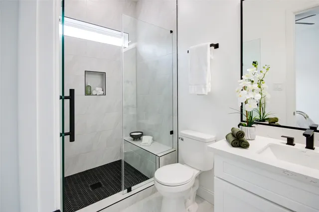 a bathroom with a granite countertop shower