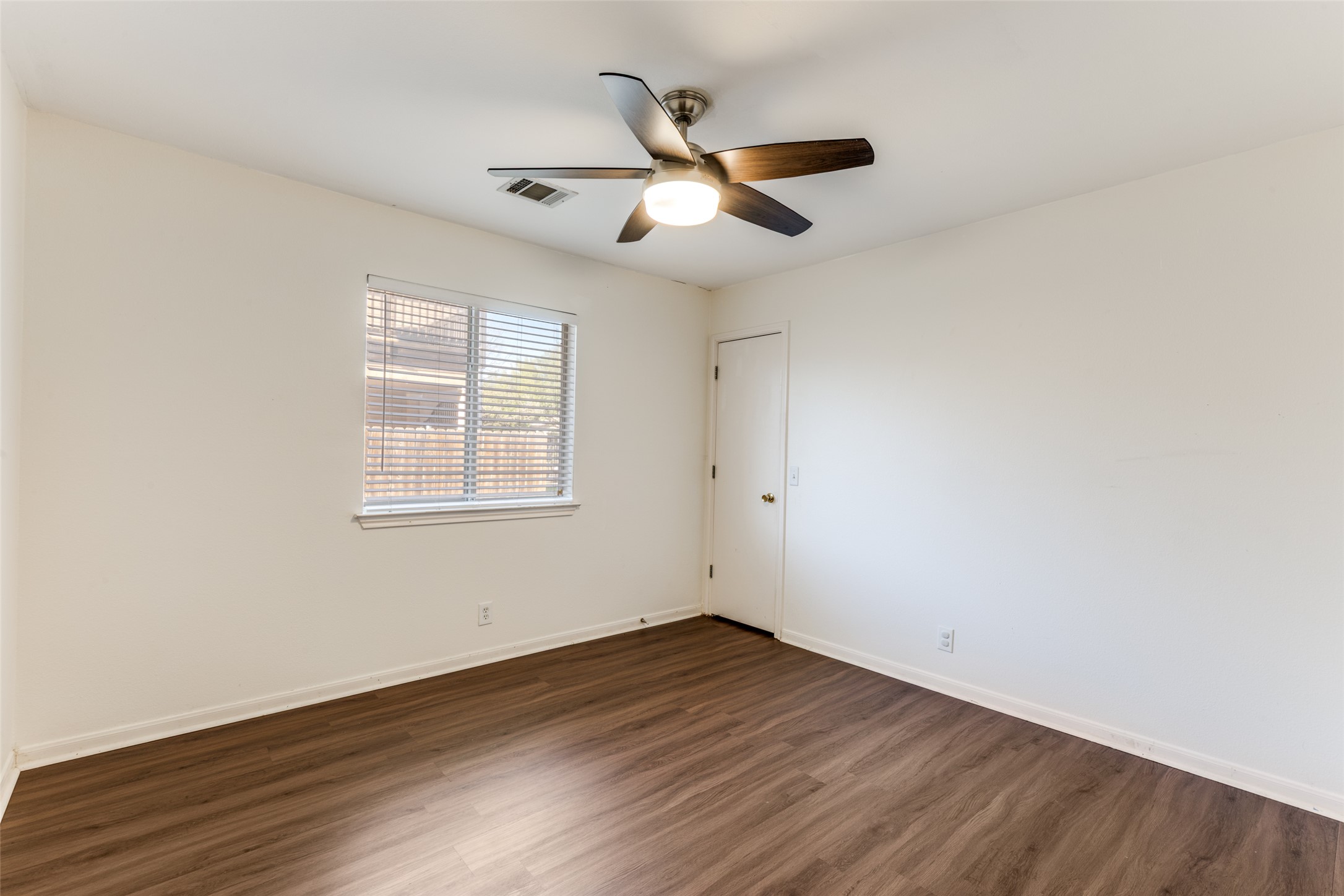 272 Tobin Drive Buda, TX 78610 - Photo 16 of 25 Spare room with dark wood-style floors and a ceiling fan