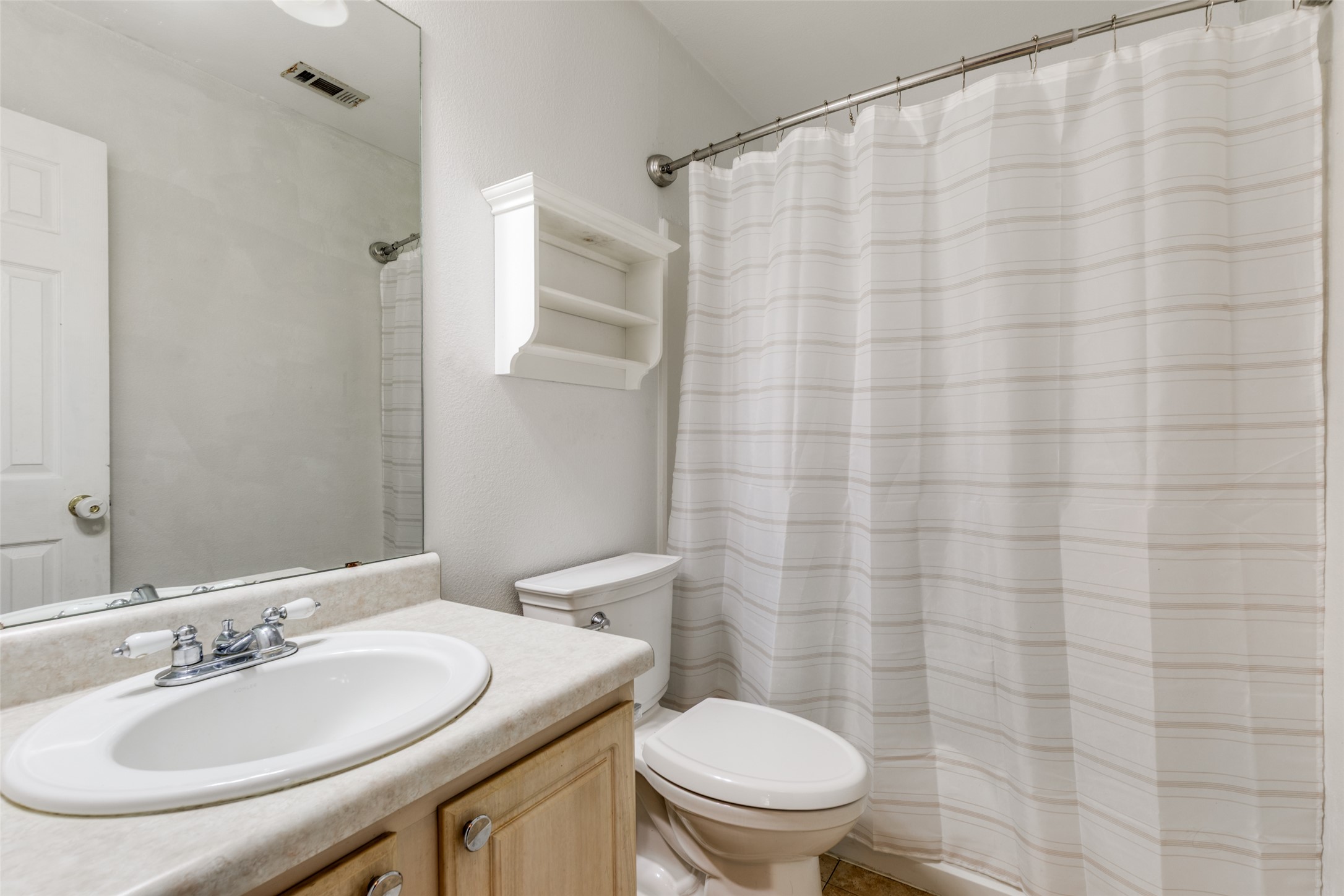 272 Tobin Drive Buda, TX 78610 - Photo 17 of 25 Full bathroom with vanity and a shower with shower curtain