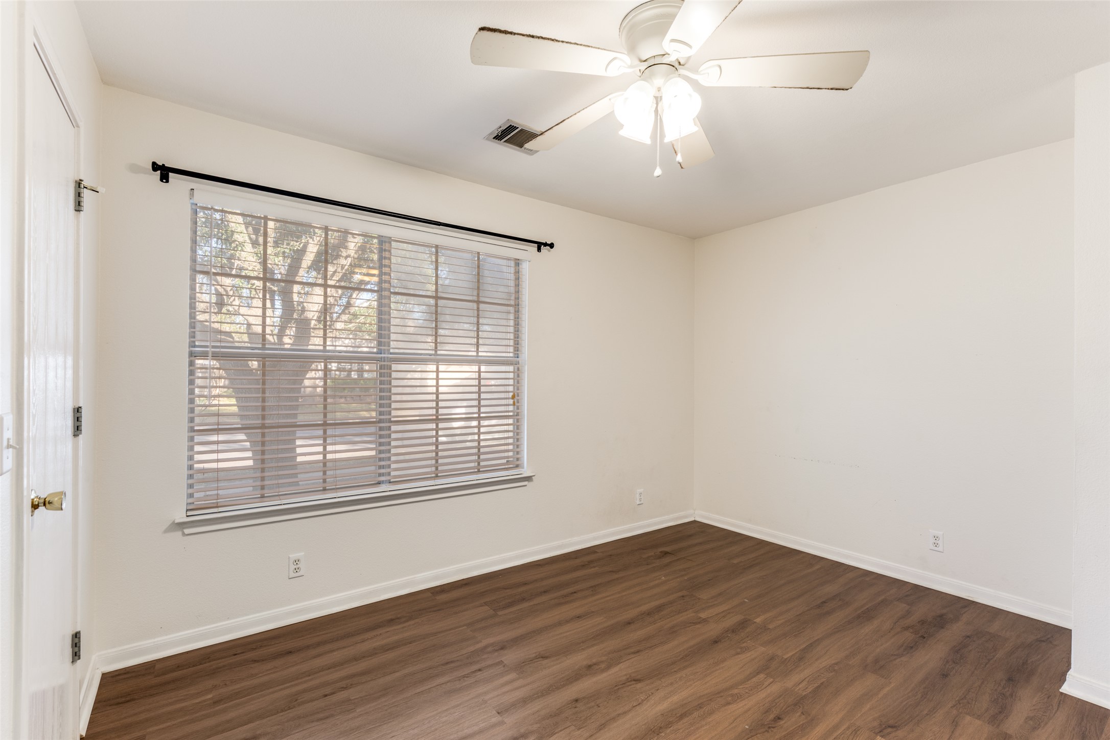 272 Tobin Drive Buda, TX 78610 - Photo 18 of 25 Unfurnished room featuring a ceiling fan and dark wood-type flooring