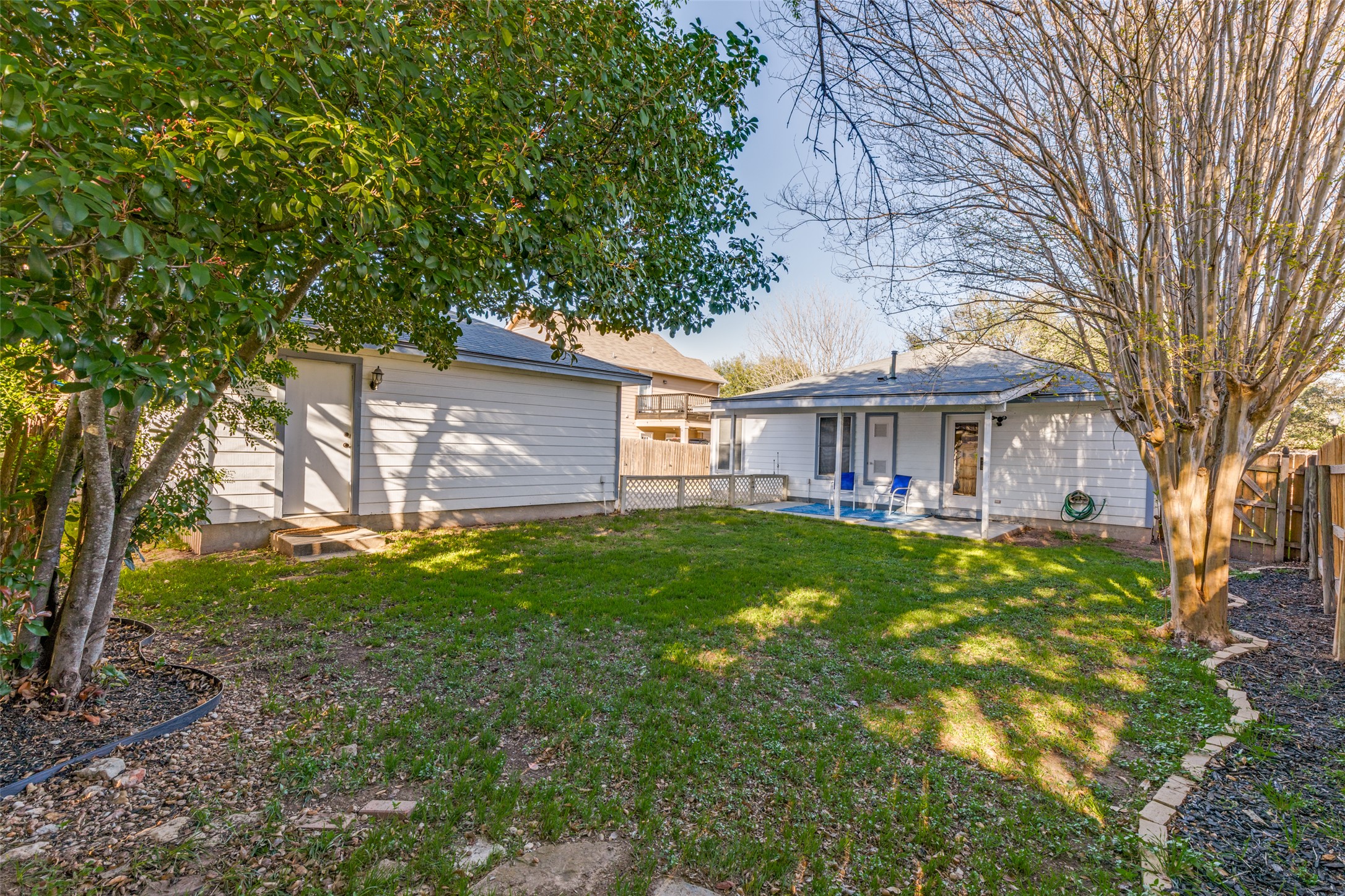 272 Tobin Drive Buda, TX 78610 - Photo 22 of 25 Back of property with a fenced backyard and a patio area