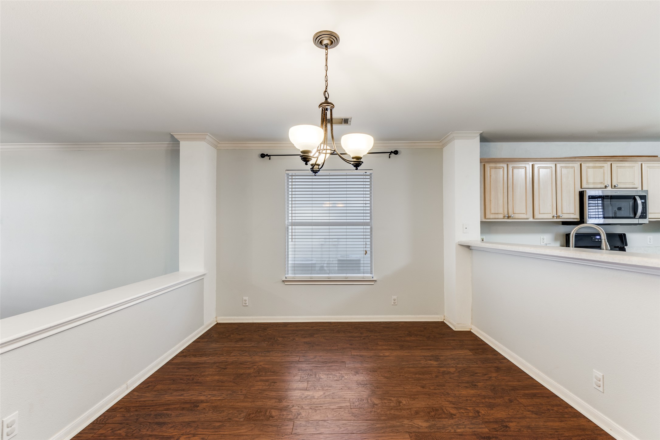 272 Tobin Drive Buda, TX 78610 - Photo 7 of 25 Unfurnished dining area with a chandelier, dark wood-style floors, and crown molding
