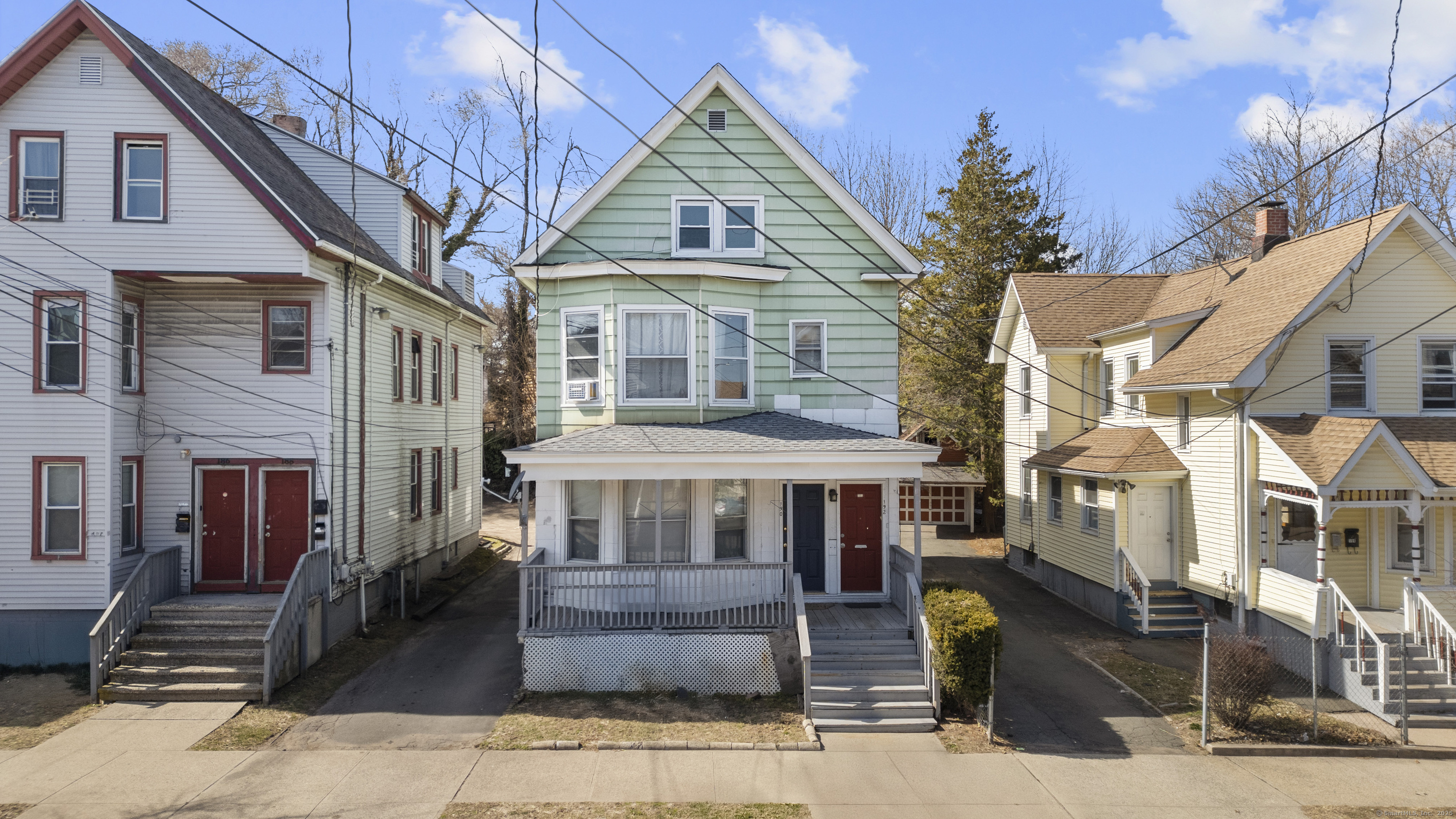 a front view of a residential apartment building with a yard