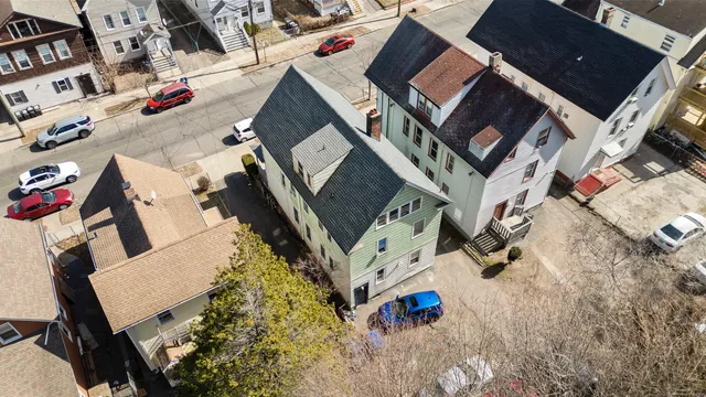 an aerial view of a house with a yard