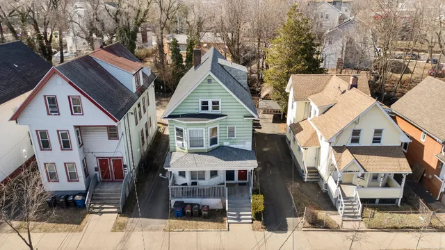 a view of a white house with large windows