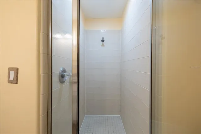 a bathroom with a glass shower door