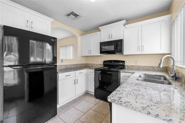 a kitchen with a refrigerator stove and sink
