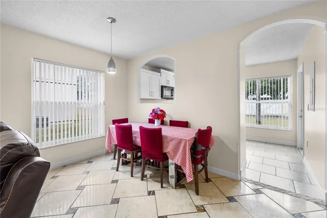 a dining room with furniture and window