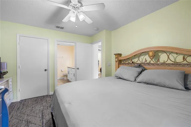 a bedroom with a large bed and a chandelier