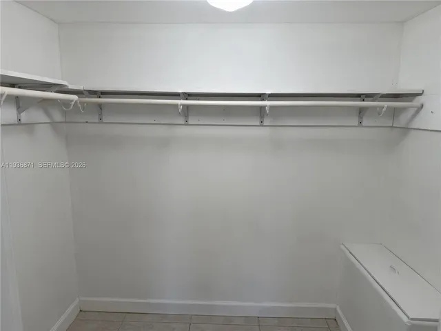 a view of a closet with racks on the wall