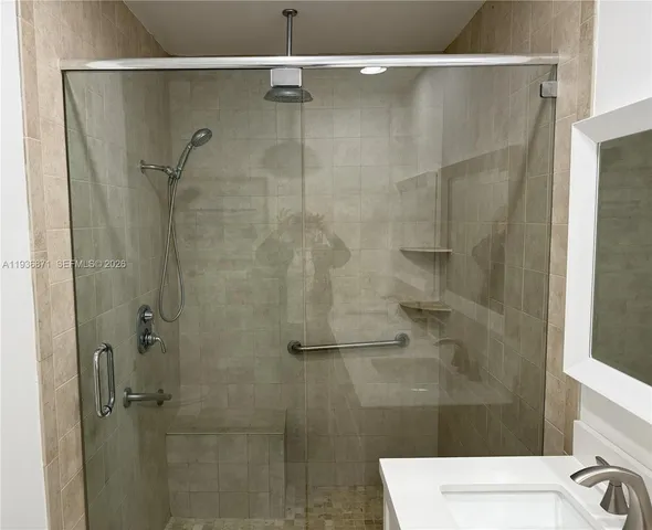a bathroom with a shower and a sink