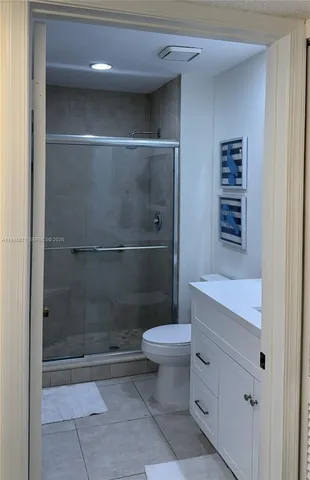a bathroom with a shower a toilet and a sink
