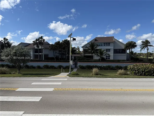 a front view of a house with a yard and a garage