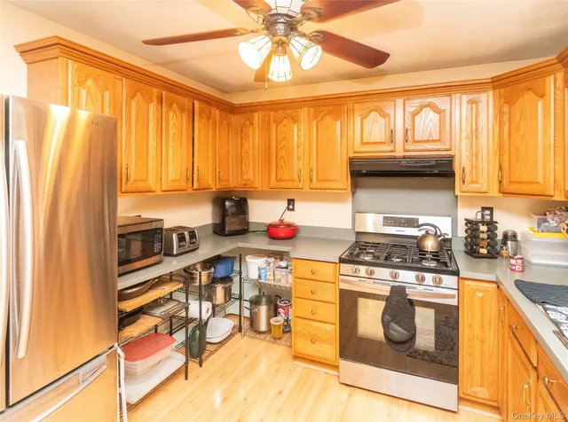 a kitchen with a stove a sink and a refrigerator