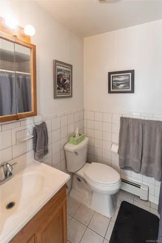 a bathroom with a toilet a sink and mirror