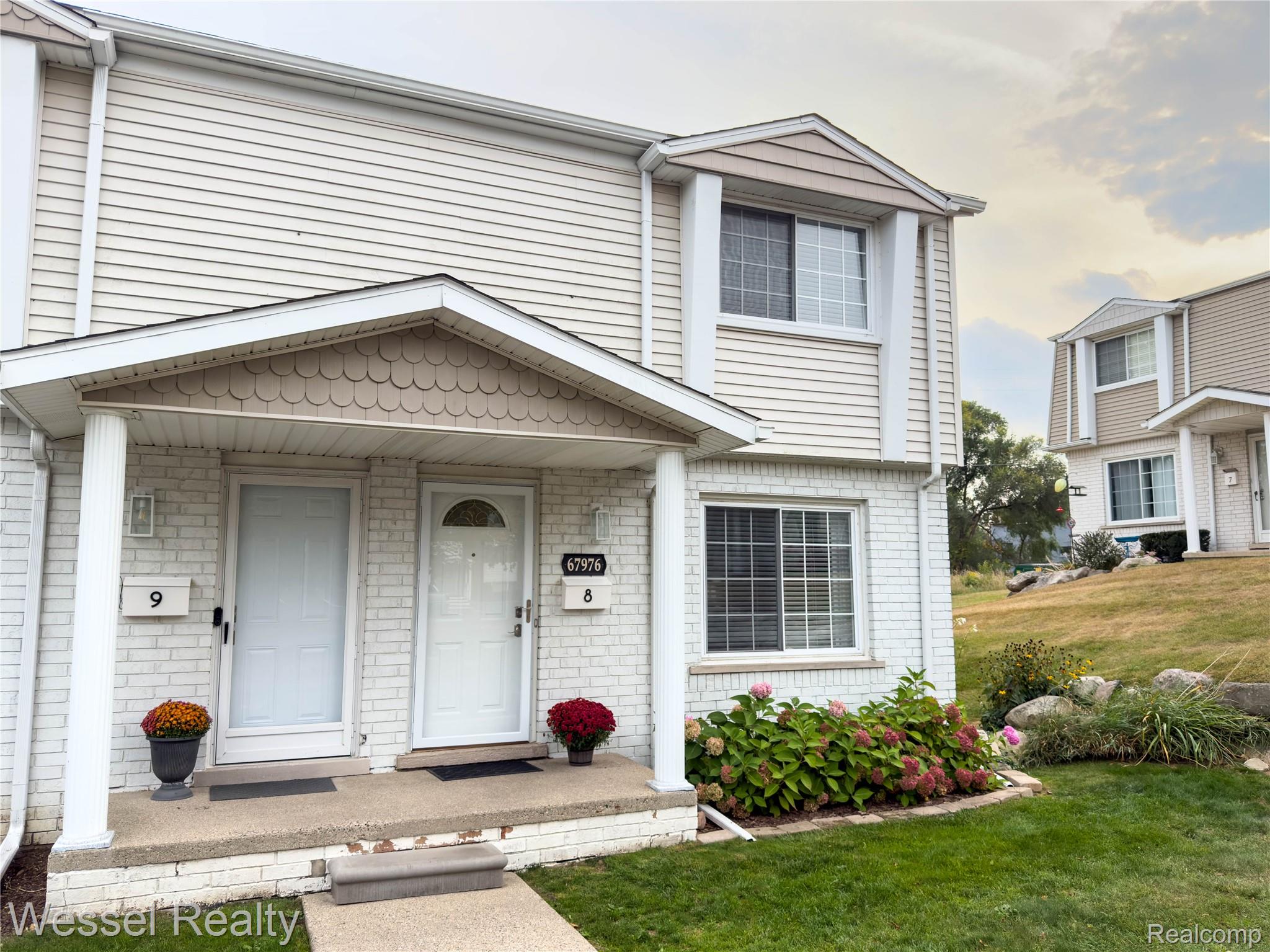 67976 Van Dyke Road, Unit 8 Washington, MI 48095 - Photo 2 of 27 View of front of house with a front yard and brick siding