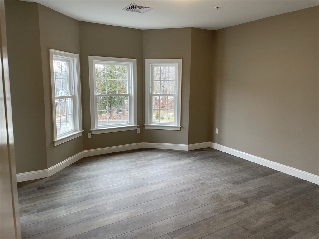 1 Brattle Street, Unit 1 Worcester, MA 01606 - Photo 15 of 21 an empty room with wooden floor and windows