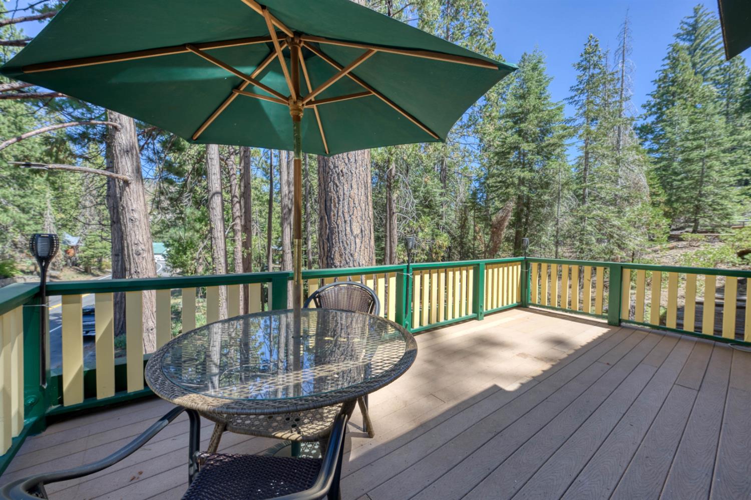 42025 Tollhouse Road Shaver Lake, CA 93664 - Photo 17 of 64 a view of balcony with furniture and umbrella
