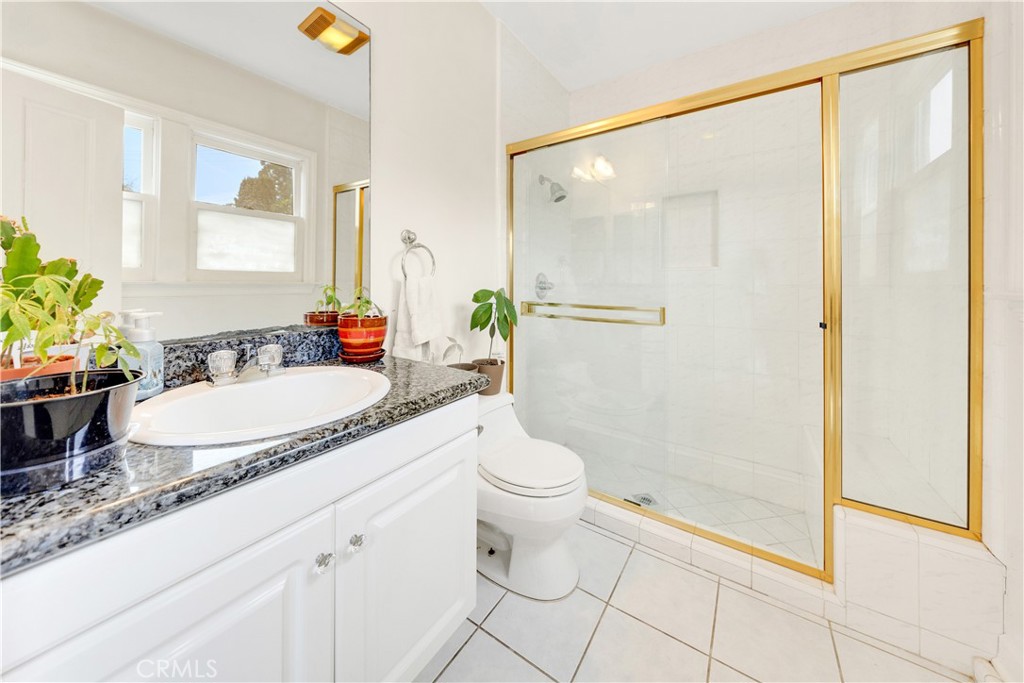 2835 Devonport Road San Marino, CA 91108 - Photo 25 of 54 a bathroom with a granite countertop sink toilet and shower