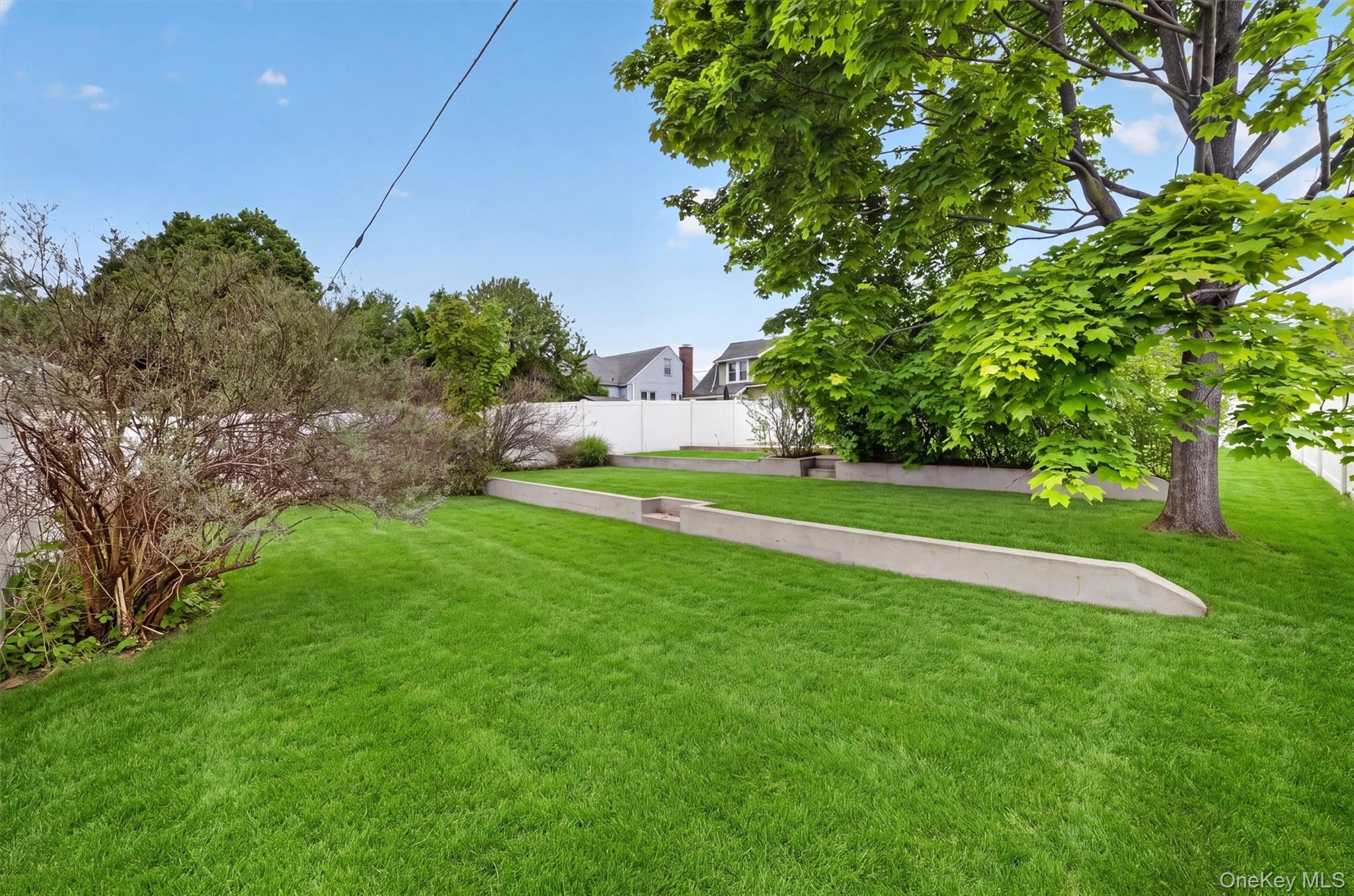 658 Ridge Street Peekskill, NY 10566 - Photo 37 of 44 Expansive lawn area featuring a tiered design with concrete retaining walls.