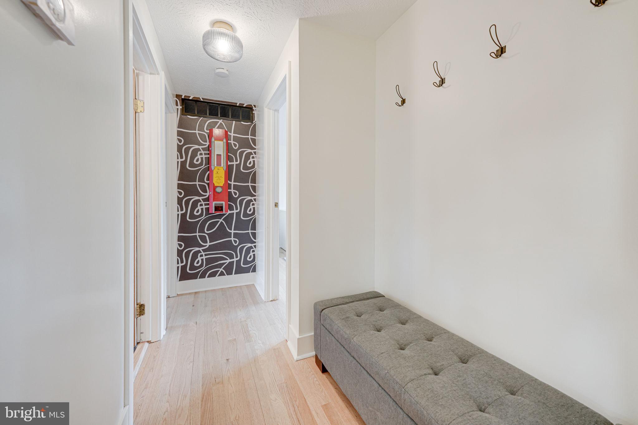 4425 Cub Run Road Chantilly, VA 20151 - Photo 22 of 43 a view of a hallway with wooden floor and a bathroom