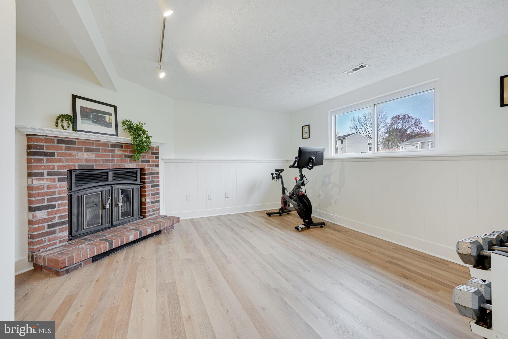 4425 Cub Run Road Chantilly, VA 20151 - Photo 27 of 43 a view of a livingroom with a fireplace and a chandelier