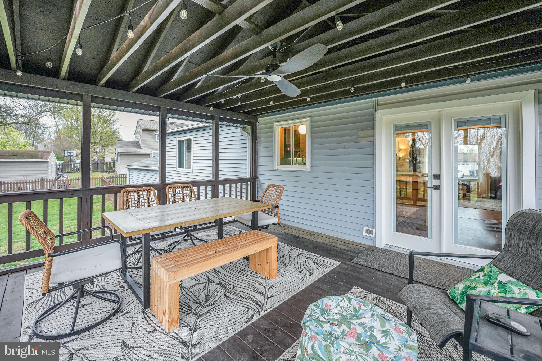 4425 Cub Run Road Chantilly, VA 20151 - Photo 34 of 43 a view of a patio with table and chairs potted plants with floor to ceiling window