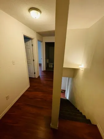 a view of a hallway view with wooden floor and staircase