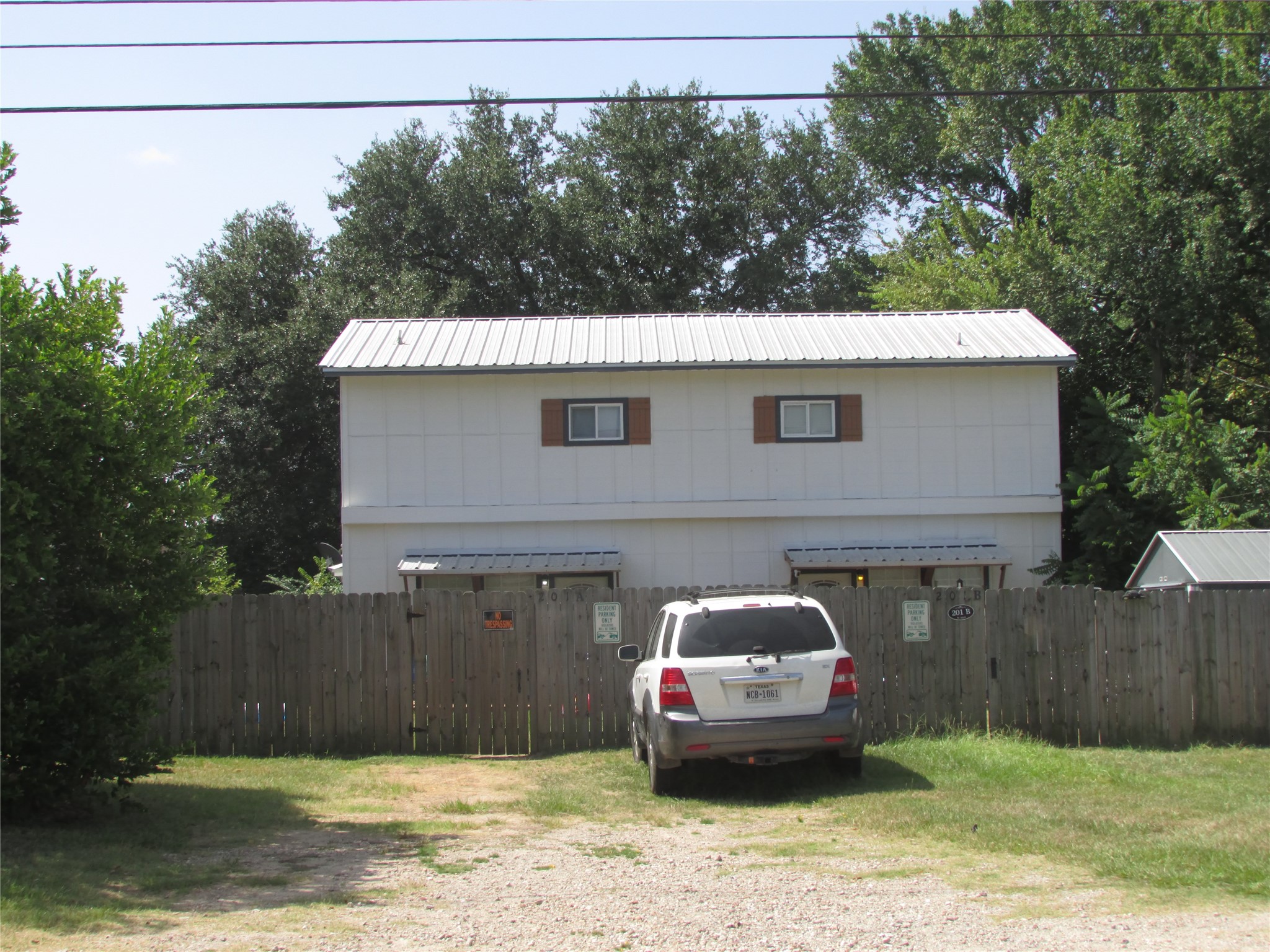 201-a&b West Mink Street Willis, TX 77378 - Photo 2 of 18 a front view of a house with a garden