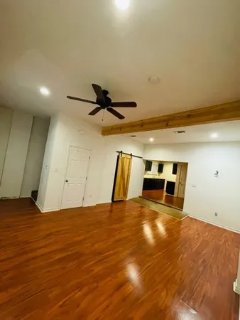 a view of a room with wooden floor