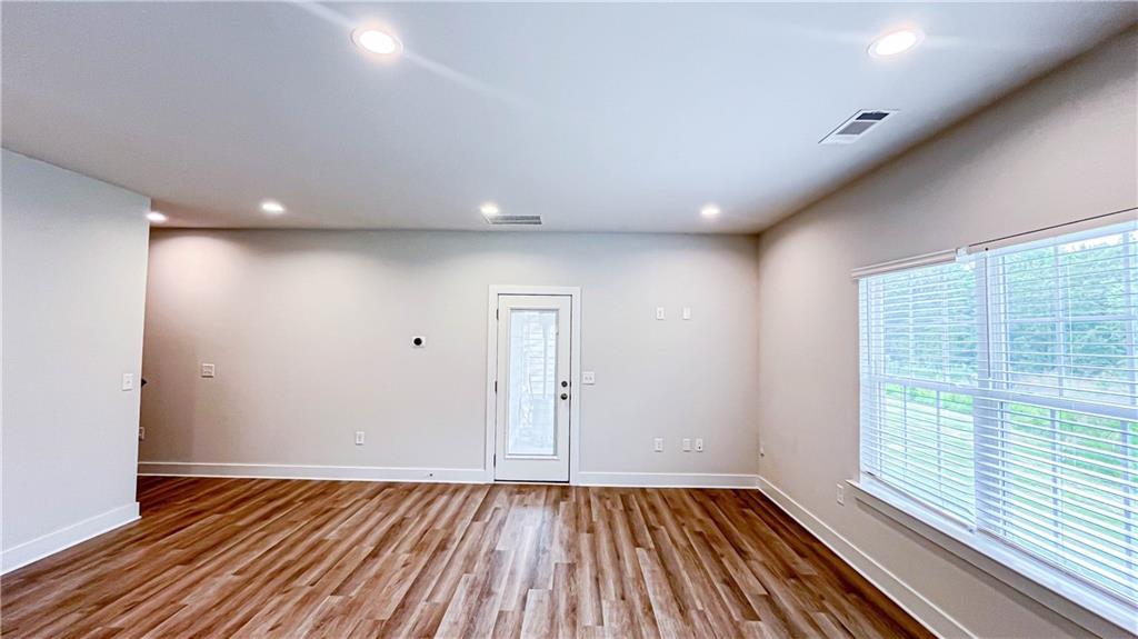 740 Eudora Welty Way Athens, GA 30607 - Photo 9 of 57 a view of an empty room with wooden floor and a window
