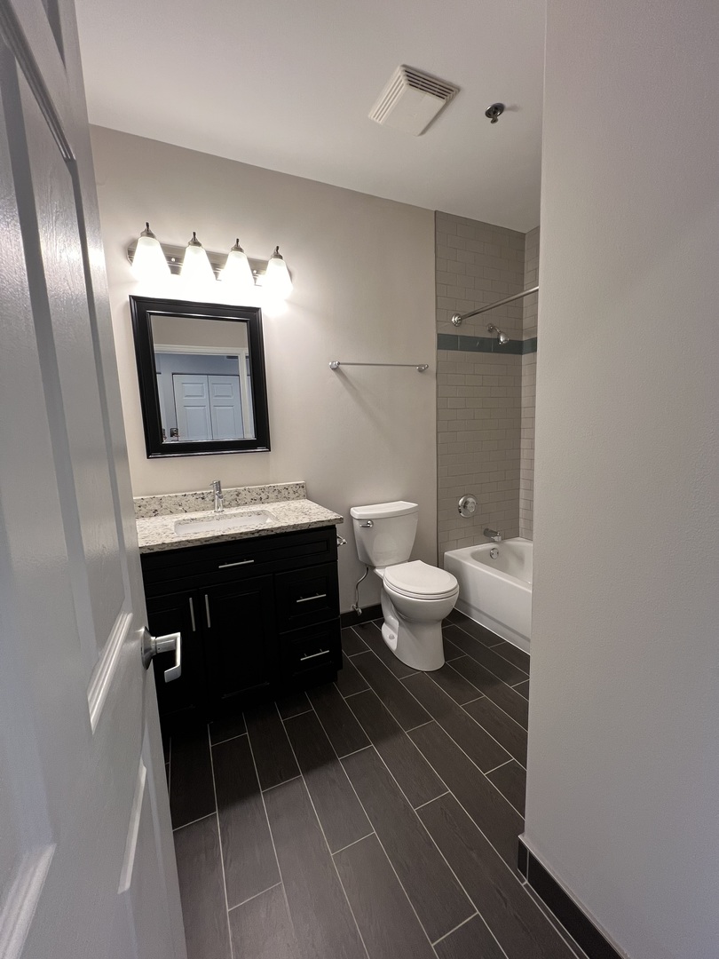 625 Deerfield Road, Unit 402 Deerfield, IL 60015 - Photo 5 of 5 a bathroom with a sink toilet and a mirror