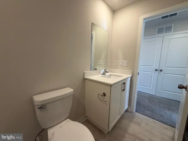 a utility room with a sink a toilet and shower