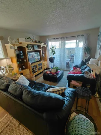 a living room with furniture and a chair