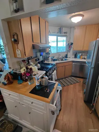 a kitchen with a sink appliances and cabinets